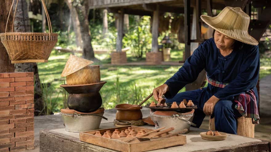 Woman makes traditional Thai khanom khrok  (coconut rice pancakes)
