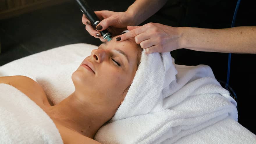 Woman on spa treatment table gets a Hydrafacial
