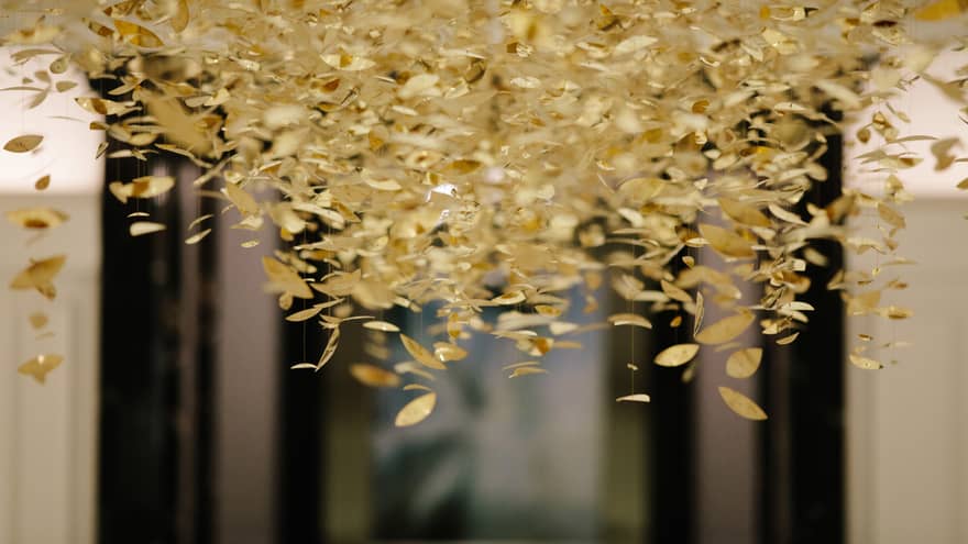 Gold leaves hanging from a ceiling.