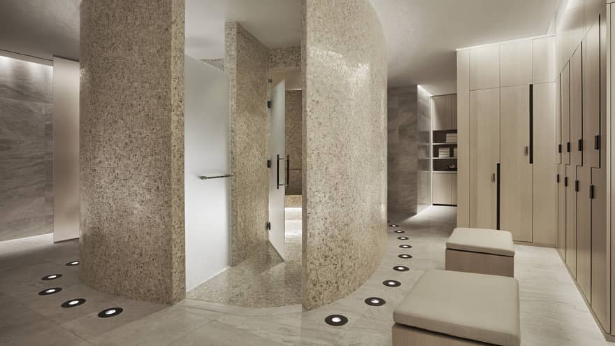 Curved white stone walls in Spa locker room, wood lockers 