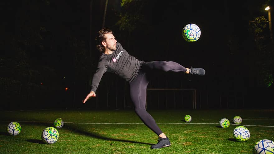 POWA by sphere session, Michael Chabala kicks soccer ball in mid-air on field with multiple balls at night