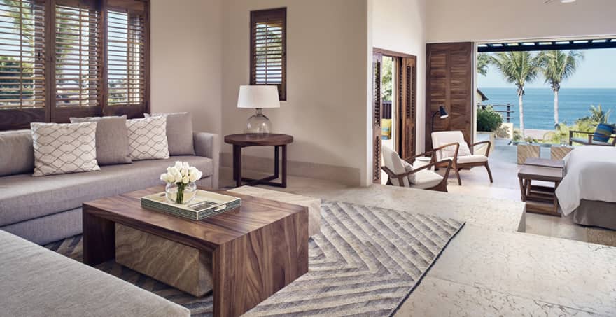 Living room with step down into king bedroom and ocean view