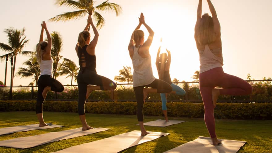 A woman doing yoga on the beach