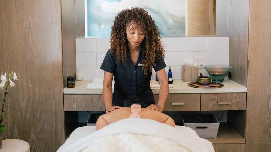 A spa tea member giving a massage.