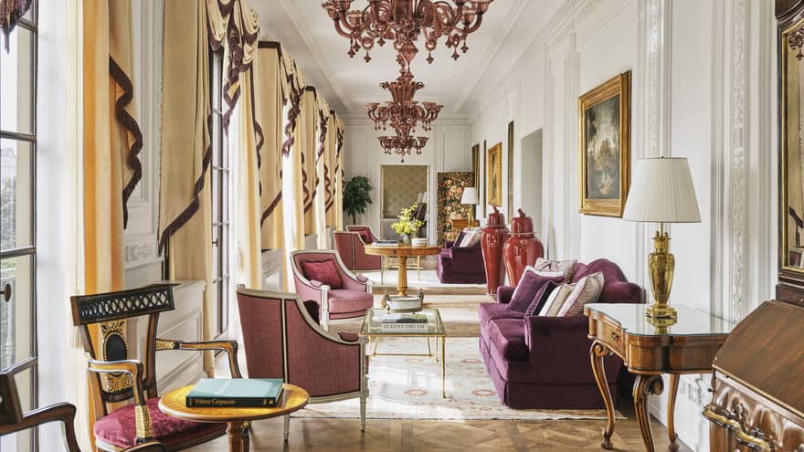 Grand hallway with chandeliers and plum-coloured sofas and chairs, Royal Suite at Four Seasons Hotel Florence