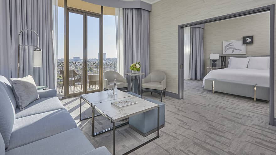 Hotel suite living room with balcony and separate bedroom