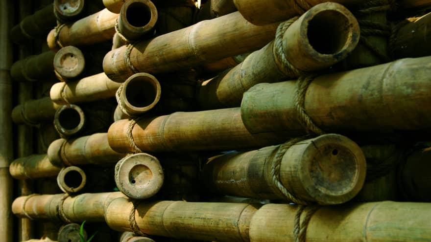 Stacked bamboo in a dimly lit space