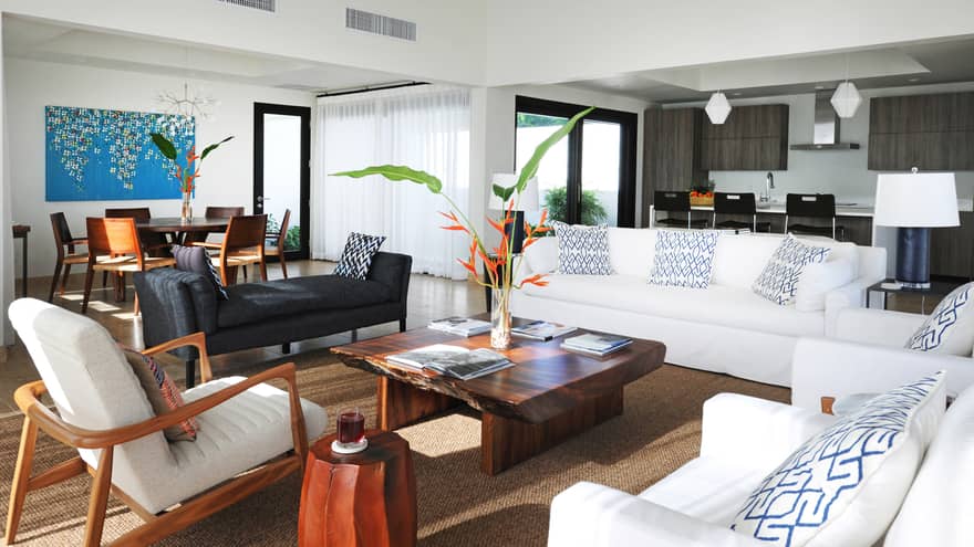 Pinney's Beach Residence Villa living room with white sofas, chairs, rustic wood table