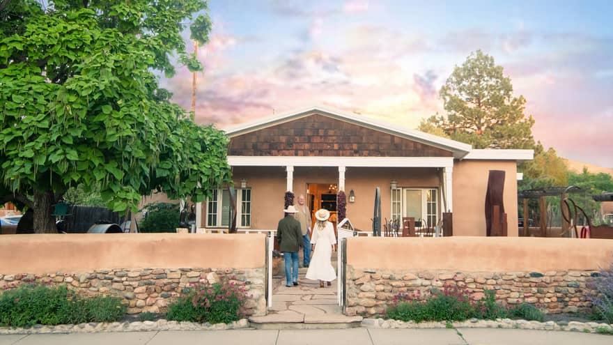 A man and woman walking up to a small building.