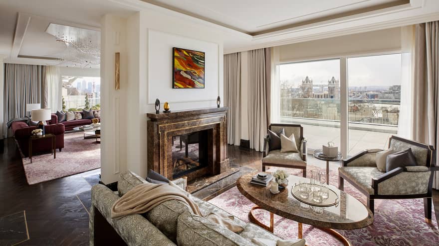 Elegant residence living room with fireplace and tall windows with river views