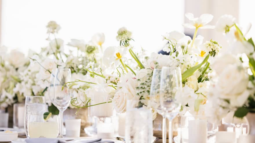 White floral arrangement set on a banquet table ready for an event