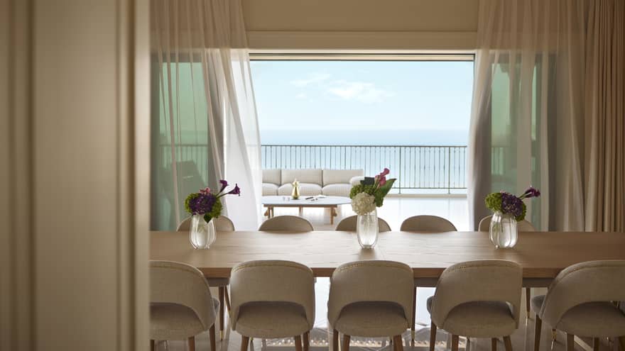 Luxury suite dining room with sea view and table with 10 chairs