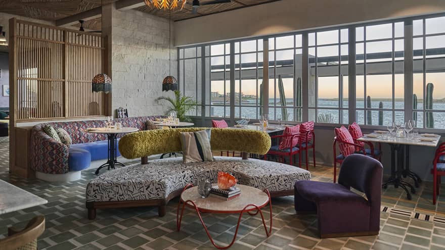 A seating area with colourful and patterned seats.
