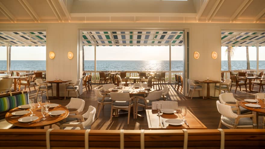 A sunlit dining room overlooking the ocean