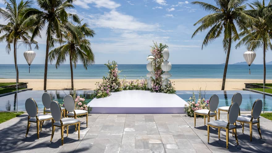 Wedding setup on the beach overlooking the ocean on a sunny day