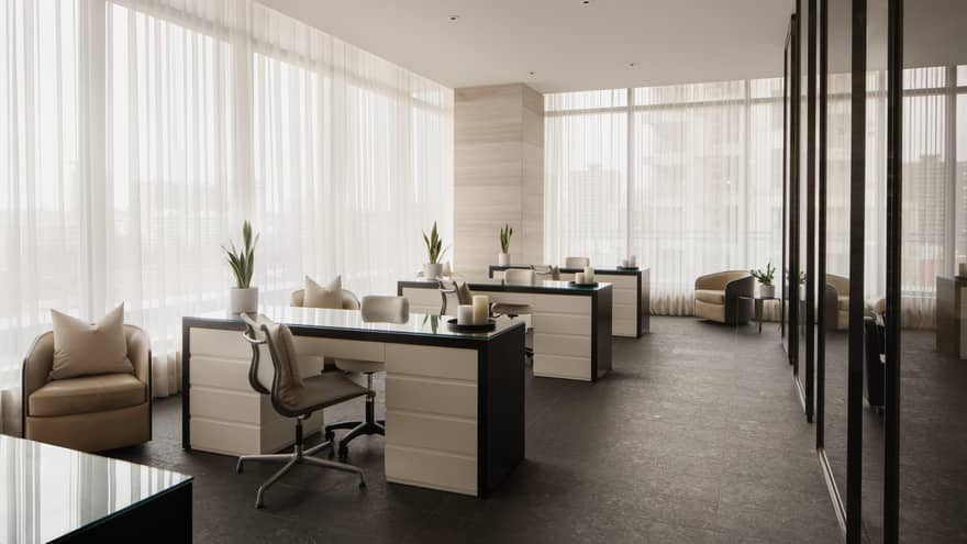 Nail salon with three black and white stations, floor-to-ceiling windows with sheer white curtains