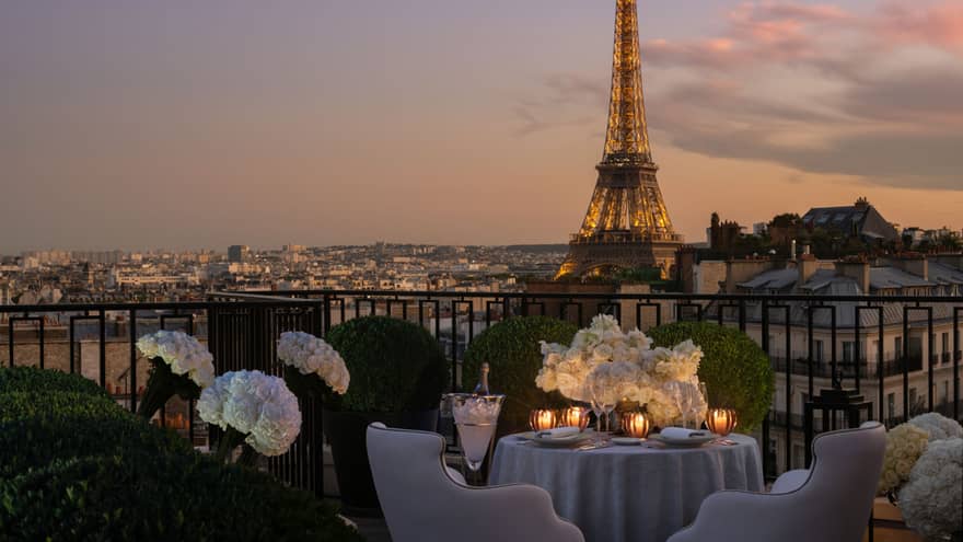 Private terrace set for dinner with prime view of the Eiffel Tower in the evening