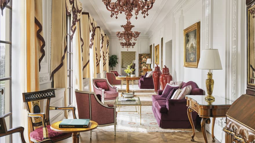 Grand hallway with chandeliers and plum-coloured sofas and chairs, Royal Suite at Four Seasons Hotel Florence