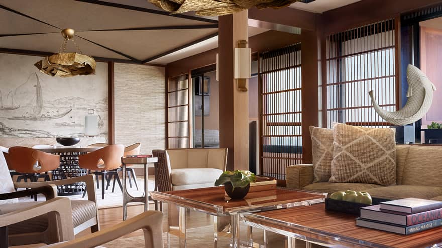 Manele Suite living room with modern furniture with wood accents, shutters, woven pillows