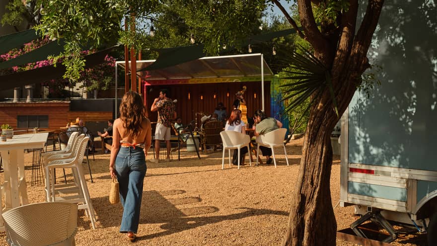 An outdoor dining area surrounded by trees and a band playing music