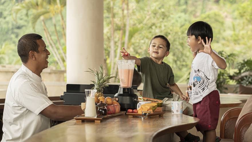 Two young boys make Jati Bar milkshakes with bartender