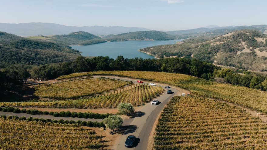 Aerial view of cars driving through a vineyard in Napa Valley