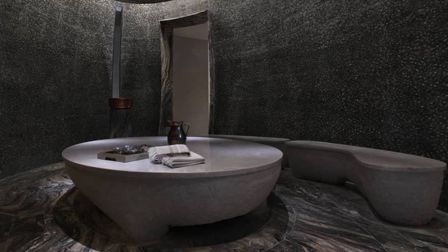 Round marble table and benches in hammam spa room