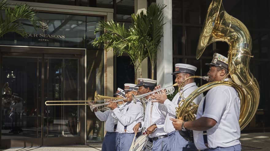 A group of men playing brass instruments outside.