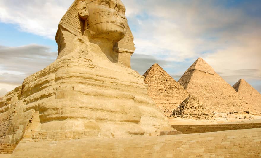 Famouse Sphinx and the great pyramids under interesting evening clouds, Cairo, Egypt