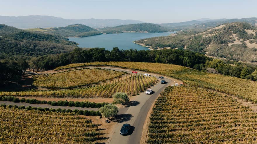 Aerial view of cars driving through a vineyard in Napa Valley