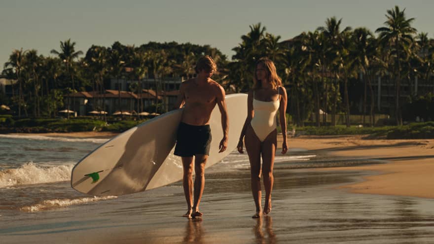 Two surfers walking on the beach