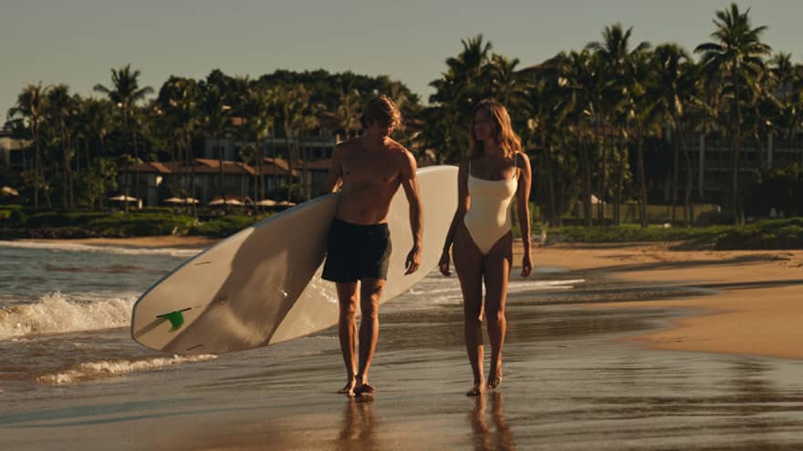 Two surfers walking on the beach