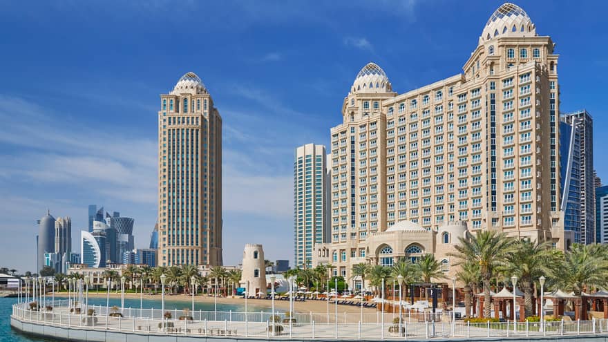 Four Seasons Doha hotel high rise building exterior, beach and palm trees