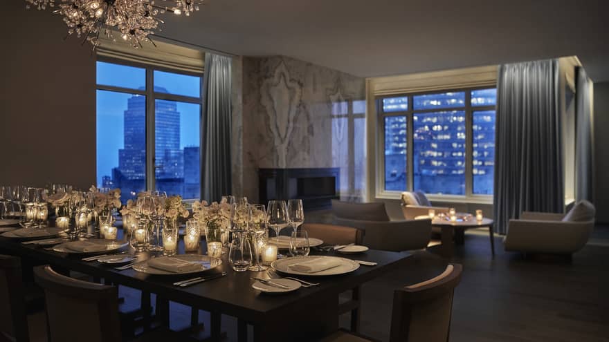 Royal Suite event set up, dining table with glowing candles near seating area