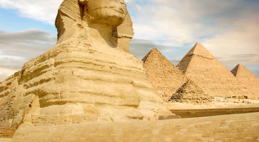 Famouse Sphinx and the great pyramids under interesting evening clouds, Cairo, Egypt
