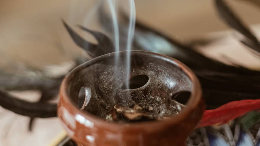 Incense burning in a small brown bowl.
