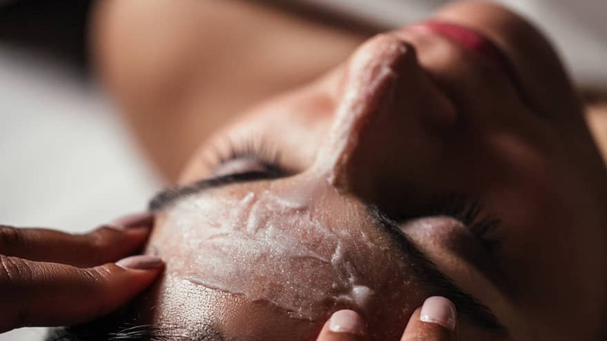 A woman getting a facial in a spa.