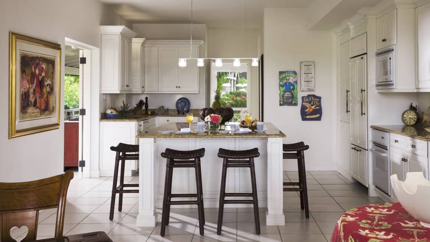 Palm Grove Residence white kitchen, island counter lined black stools