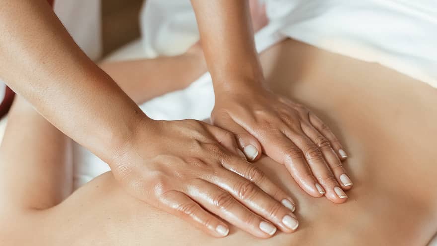 Hands performing a back massage