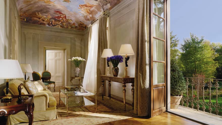 Presidential Suite sitting area under mural panel ceiling, open balcony door