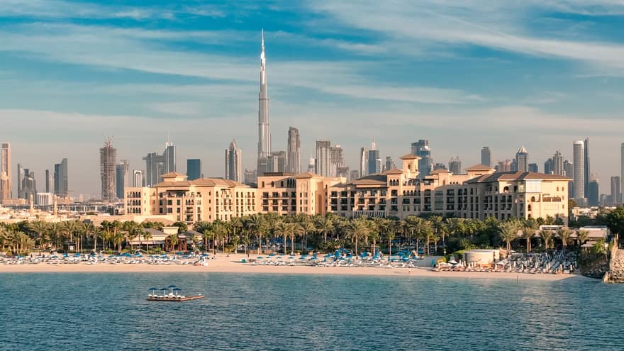 An aerial view of Jumeirah Beach from the sea with a view of downtown in the distance.