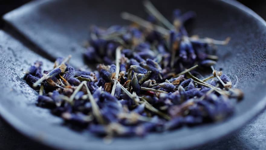 Lavender flowers in a grey bowl.