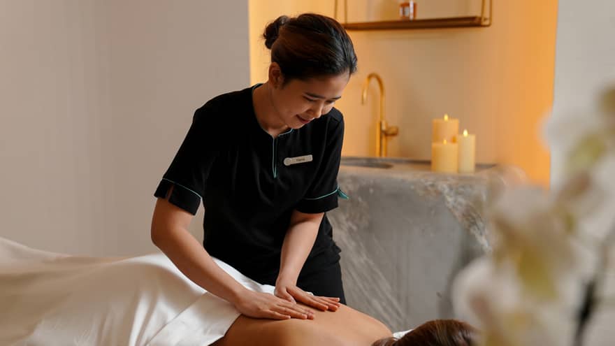 A woman receiving a massage treatment in a spa.