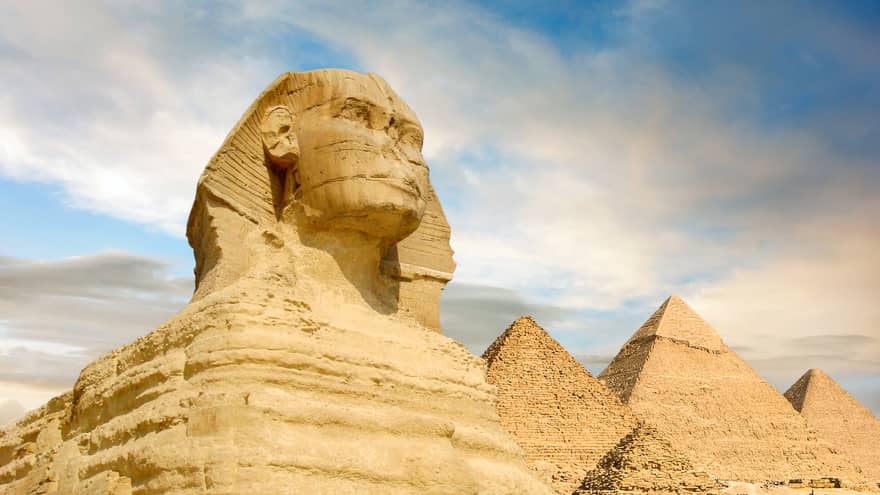 Famouse Sphinx and the great pyramids under interesting evening clouds, Cairo, Egypt