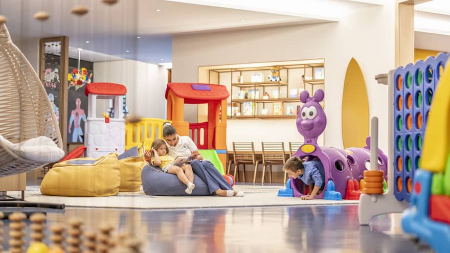 Kids playroom with colourful toys and bean-bag chairs
