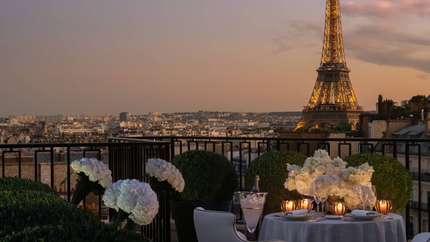 Private terrace set for dinner with prime view of the Eiffel Tower in the evening