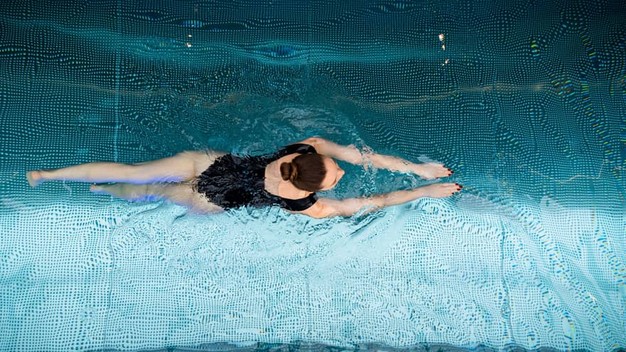 A woman swimming in a pool.