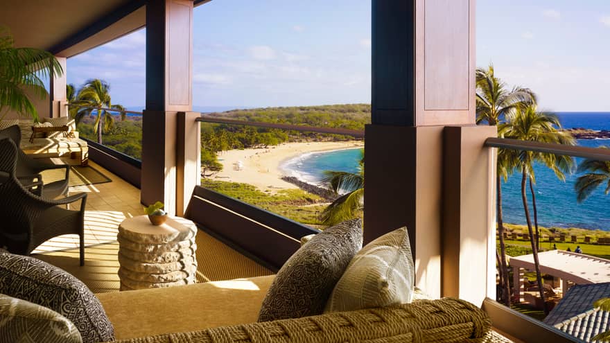 Open-air lanai with sofas, lounge furniture overlooking beach, ocean