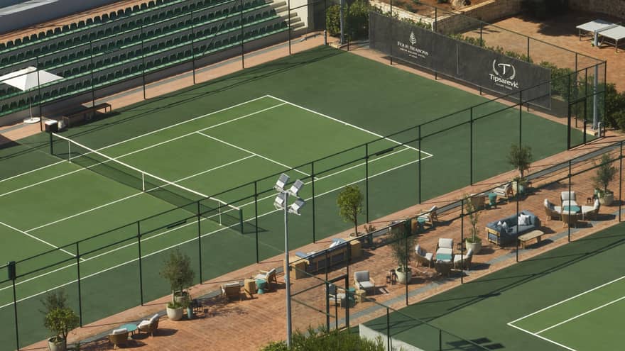 Tennis courts with seating outside the courts.