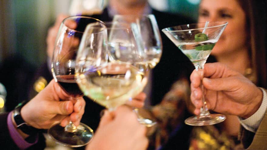 Group of friends toast with wine and martini glasses